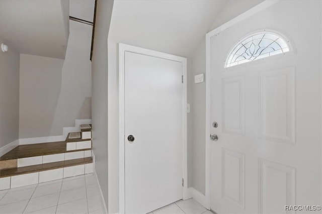 42 Magnolia Ave, Yankeetown, FL 34498 - entryway with light tile patterned floors, vaulted ceiling, and baseboards
