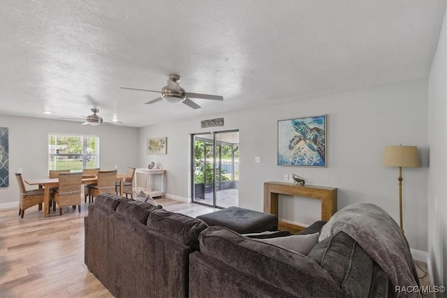 42 Magnolia Ave, Yankeetown, FL 34498 - living room featuring a ceiling fan, baseboards, and light wood-style flooring