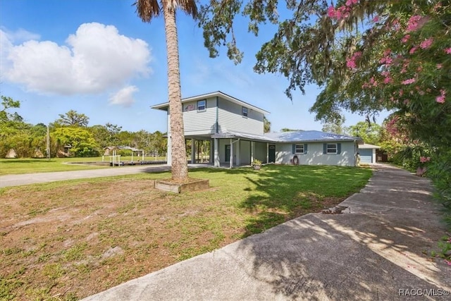 42 Magnolia Ave, Yankeetown, FL 34498 - traditional home featuring a front yard, concrete driveway, and a garage