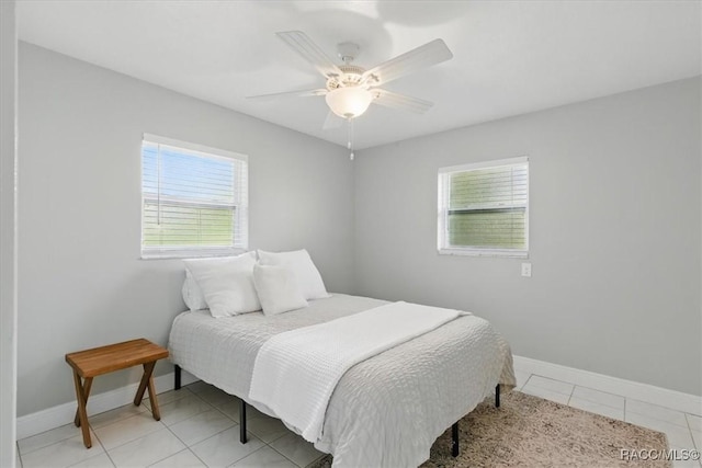 42 Magnolia Ave, Yankeetown, FL 34498 - bedroom featuring baseboards, light tile patterned floors, and a ceiling fan