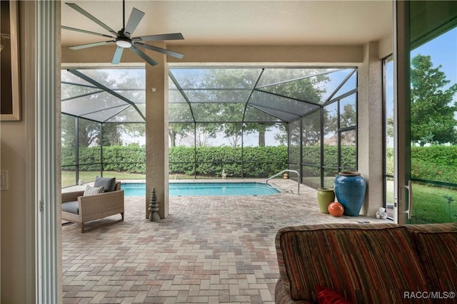 view of pool with a patio, a lanai, an outdoor hangout area, and ceiling fan