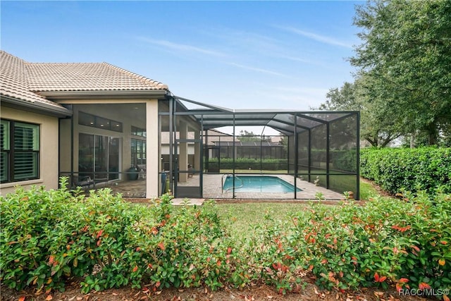 view of pool featuring a patio and glass enclosure