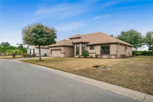 view of front of home featuring a garage and a front lawn