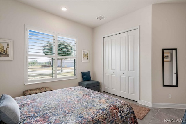 tiled bedroom featuring a closet