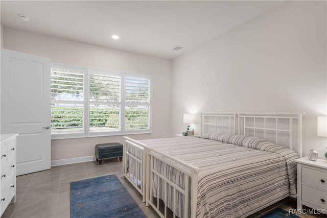 bedroom with light tile patterned floors