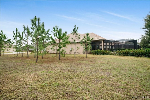 view of yard with glass enclosure