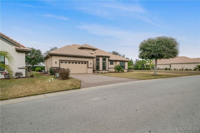 view of front of property featuring a garage and a front yard