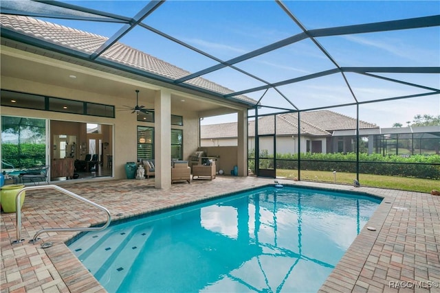 view of swimming pool featuring a patio, a lanai, an outdoor hangout area, and ceiling fan