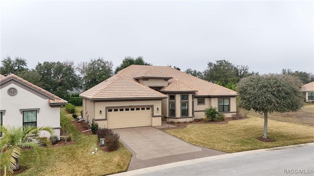 mediterranean / spanish-style home featuring a garage and a front lawn