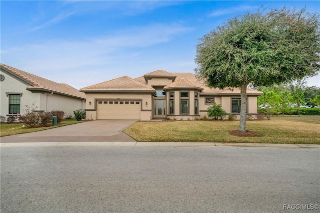 view of front of property with a garage and a front lawn