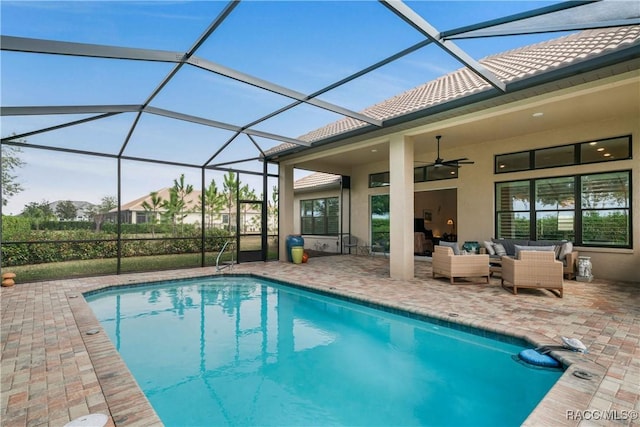 view of pool featuring ceiling fan, an outdoor living space, a patio, and glass enclosure