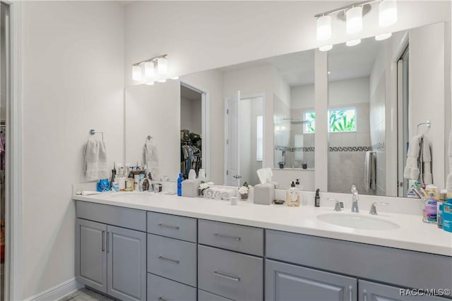 bathroom with walk in shower and vanity