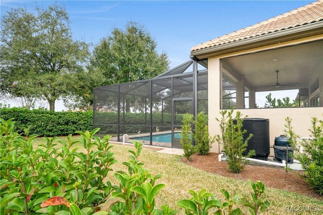 view of pool with ceiling fan, a yard, a lanai, and central air condition unit