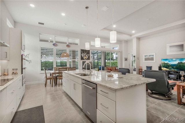 kitchen featuring sink, dishwasher, an island with sink, pendant lighting, and white cabinets