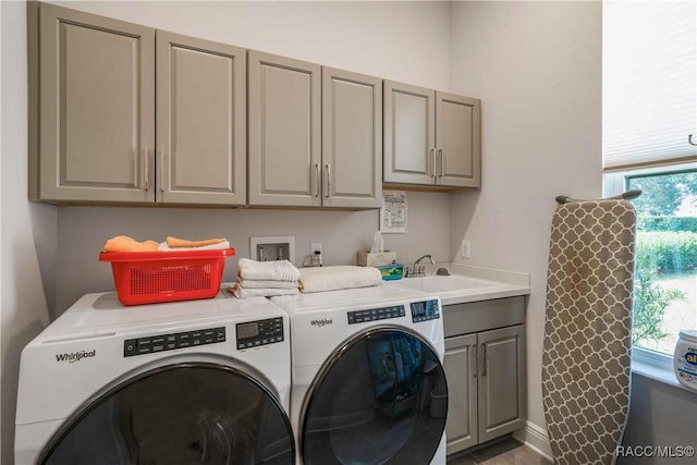 laundry area with cabinets, sink, plenty of natural light, and independent washer and dryer