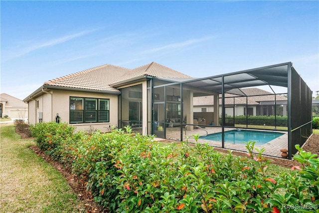 back of house with a lanai and a patio area