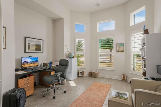 tiled office with a towering ceiling