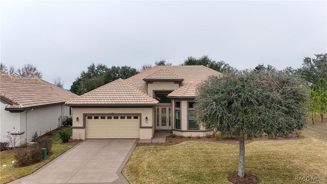 mediterranean / spanish home with a garage and a front yard