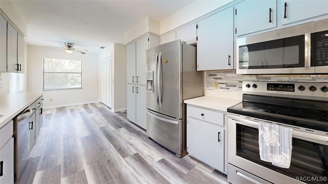 125 W Seymeria Dr, Beverly Hills, FL 34465 - kitchen with appliances with stainless steel finishes, a ceiling fan, light countertops, decorative backsplash, and light wood-style flooring