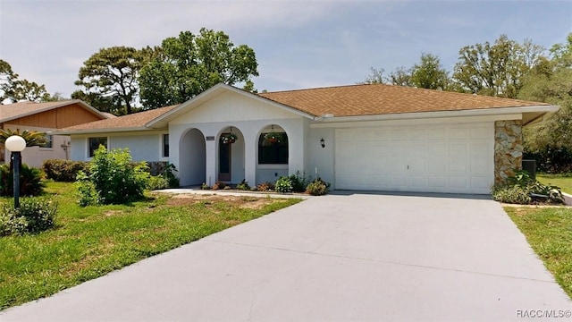 125 W Seymeria Dr, Beverly Hills, FL 34465 - single story home featuring a garage, driveway, and a front lawn