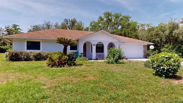 125 W Seymeria Dr, Beverly Hills, FL 34465 - ranch-style home featuring a front lawn, an attached garage, and stucco siding