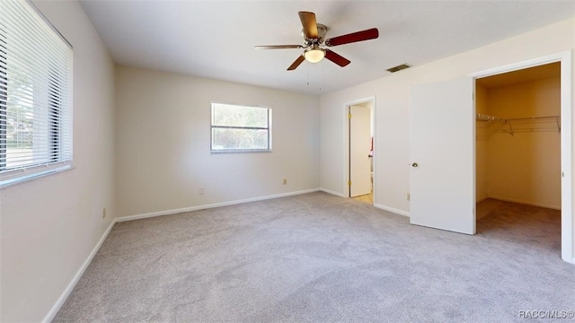 125 W Seymeria Dr, Beverly Hills, FL 34465 - unfurnished bedroom with carpet, a spacious closet, and a ceiling fan
