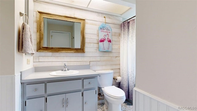 125 W Seymeria Dr, Beverly Hills, FL 34465 - bathroom featuring vanity, a wainscoted wall, wooden walls, and a shower with shower curtain