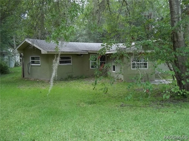 back of property featuring a yard