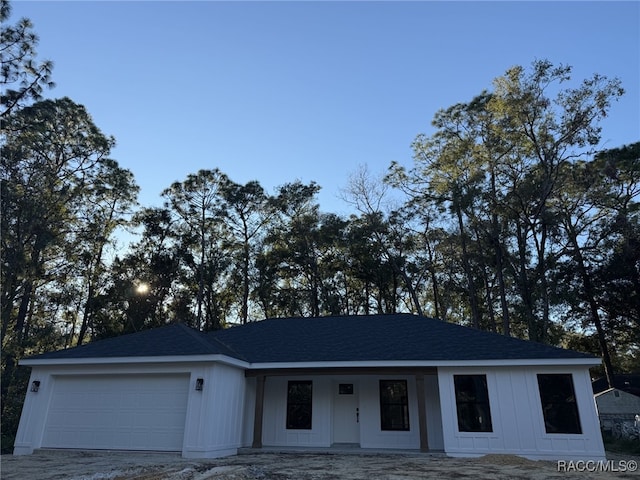 view of front facade with covered porch and a garage