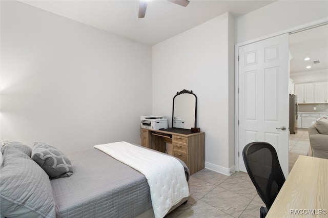 bedroom with stainless steel refrigerator, ceiling fan, and a closet