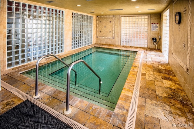 view of pool featuring an indoor hot tub