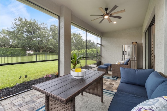 sunroom featuring ceiling fan