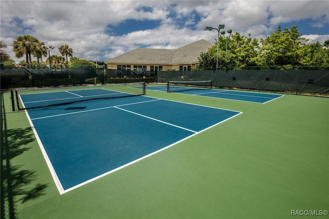 view of tennis court with basketball hoop