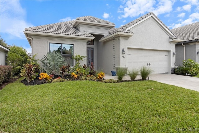 view of front of home featuring a garage and a front lawn