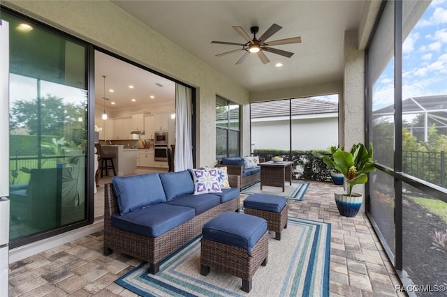 sunroom featuring a wealth of natural light and ceiling fan