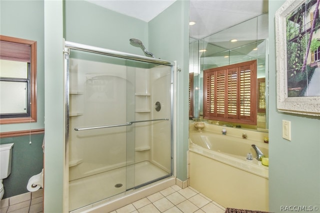 bathroom featuring tile patterned flooring, plus walk in shower, and toilet