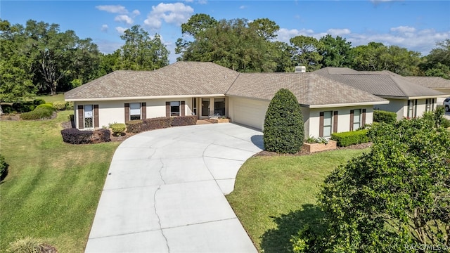 ranch-style home with a front yard and a garage