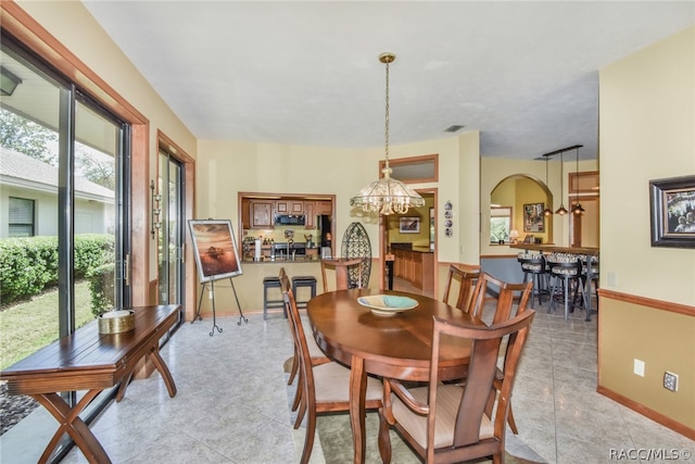 dining space featuring a chandelier and plenty of natural light