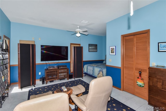 tiled bedroom with ceiling fan and a closet