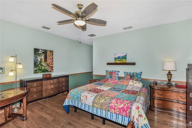 bedroom with ceiling fan and dark wood-type flooring