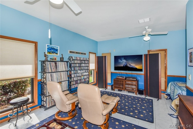 tiled living room with ceiling fan