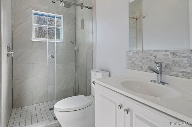 bathroom with vanity, toilet, a shower with door, and tile walls