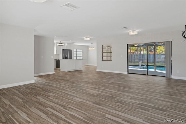 unfurnished living room with dark wood-type flooring