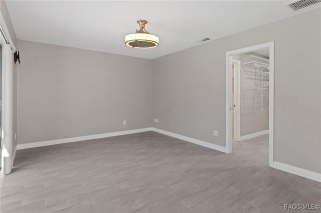 spare room featuring light hardwood / wood-style flooring