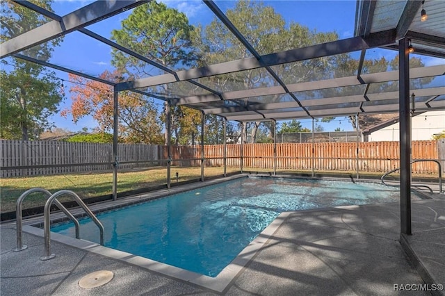 view of pool with a yard, a patio area, and a lanai