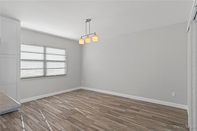 unfurnished room featuring hardwood / wood-style flooring