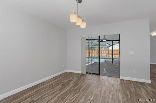 spare room featuring hardwood / wood-style flooring and ceiling fan