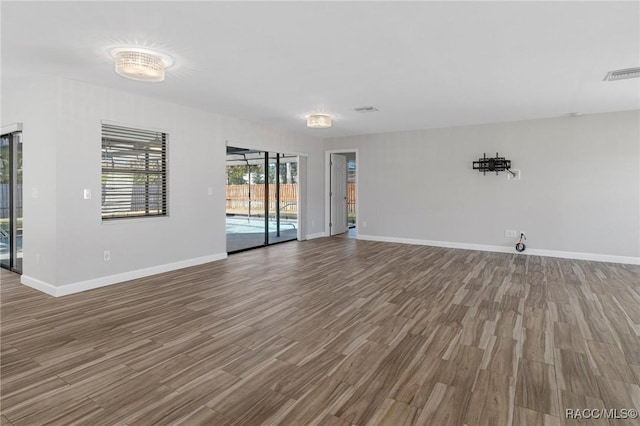 empty room with hardwood / wood-style flooring