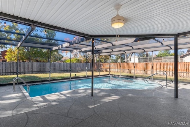 view of pool with a patio and glass enclosure