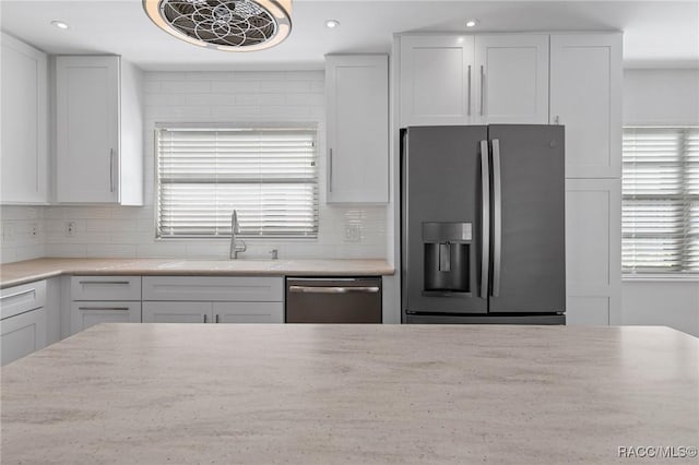 kitchen with white cabinets, sink, and stainless steel appliances